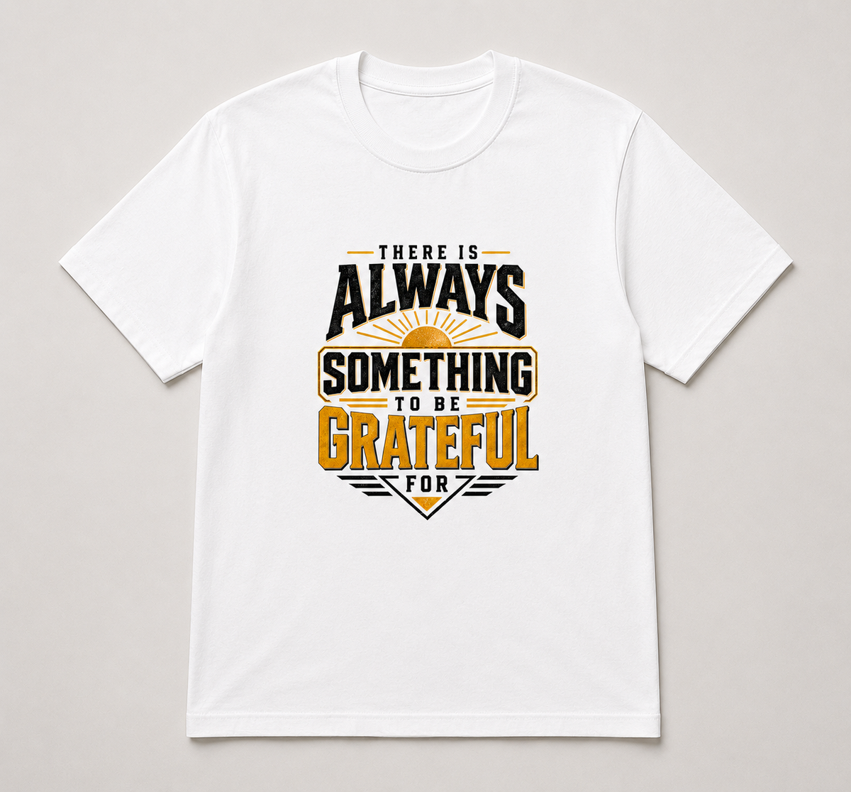 A white short-sleeve crewneck t-shirt with a graphic print on the front that reads 'THERE IS ALWAYS SOMETHING TO BE GRATEFUL FOR' in black and gold lettering with a sunburst design, displayed flat against a light gray background.