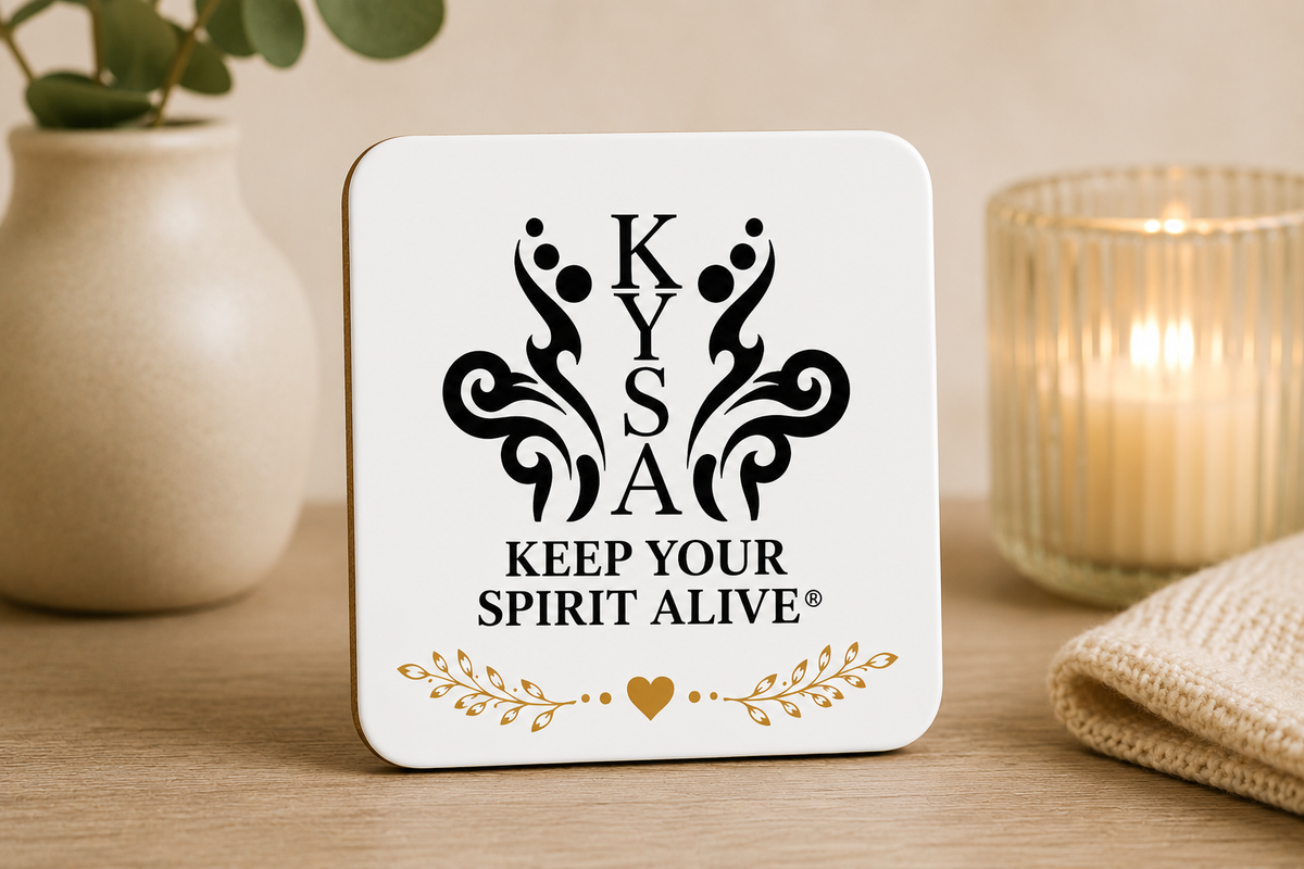 White KYSA Signature Logo coaster with black Keep Your Spirit Alive emblem and gold botanical heart detail