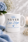 White gloss ceramic mug featuring the Never Lose Hope Signature Edition design in elegant blue and black from the Keep Your Spirit Alive® collection.